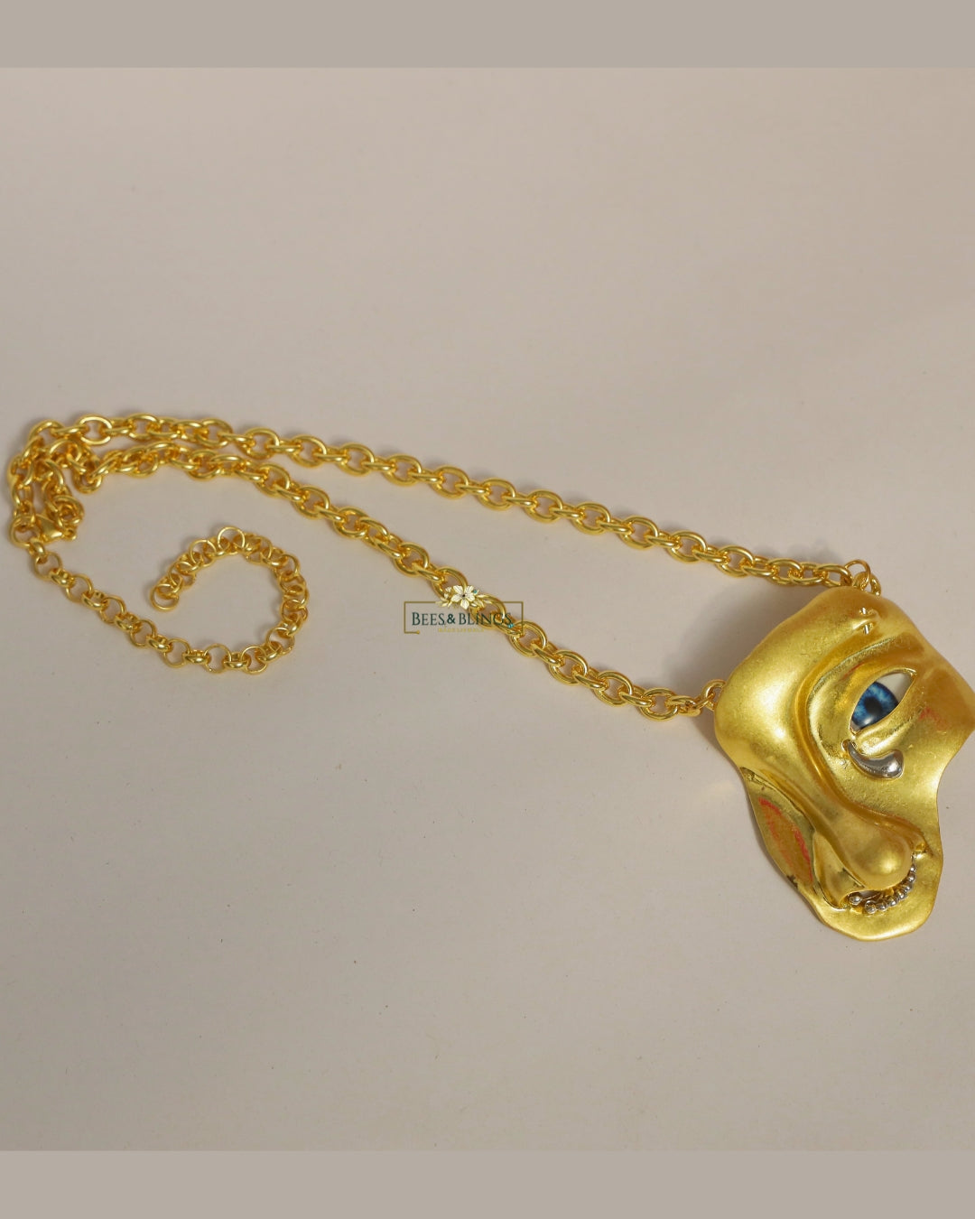 goldplated face statement necklace