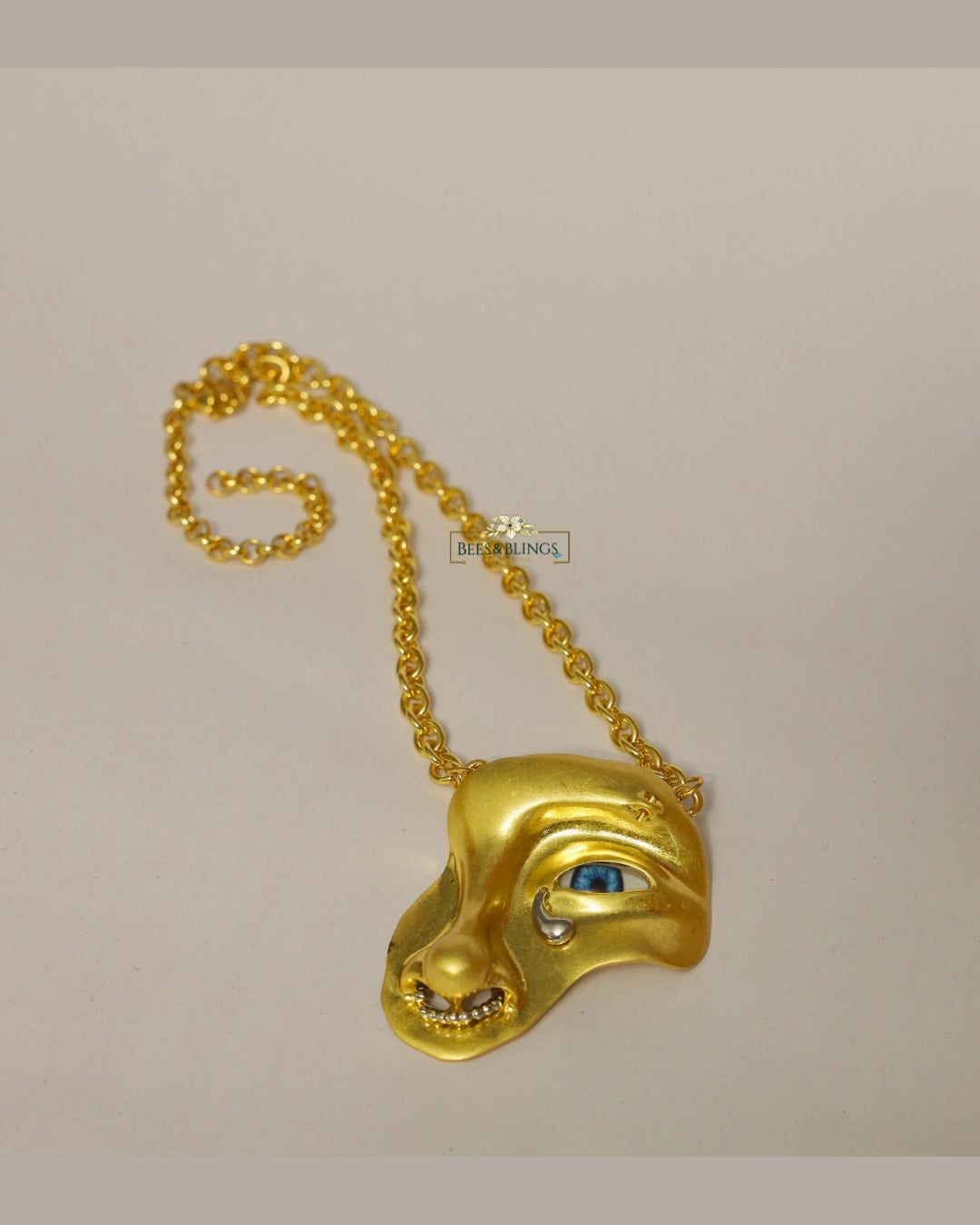 goldplated face statement necklace